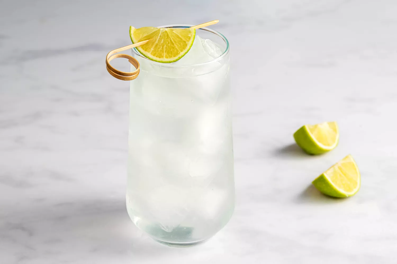 Gin rickey cocktail with lime wedge garnish